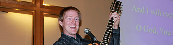 songleader on guitar